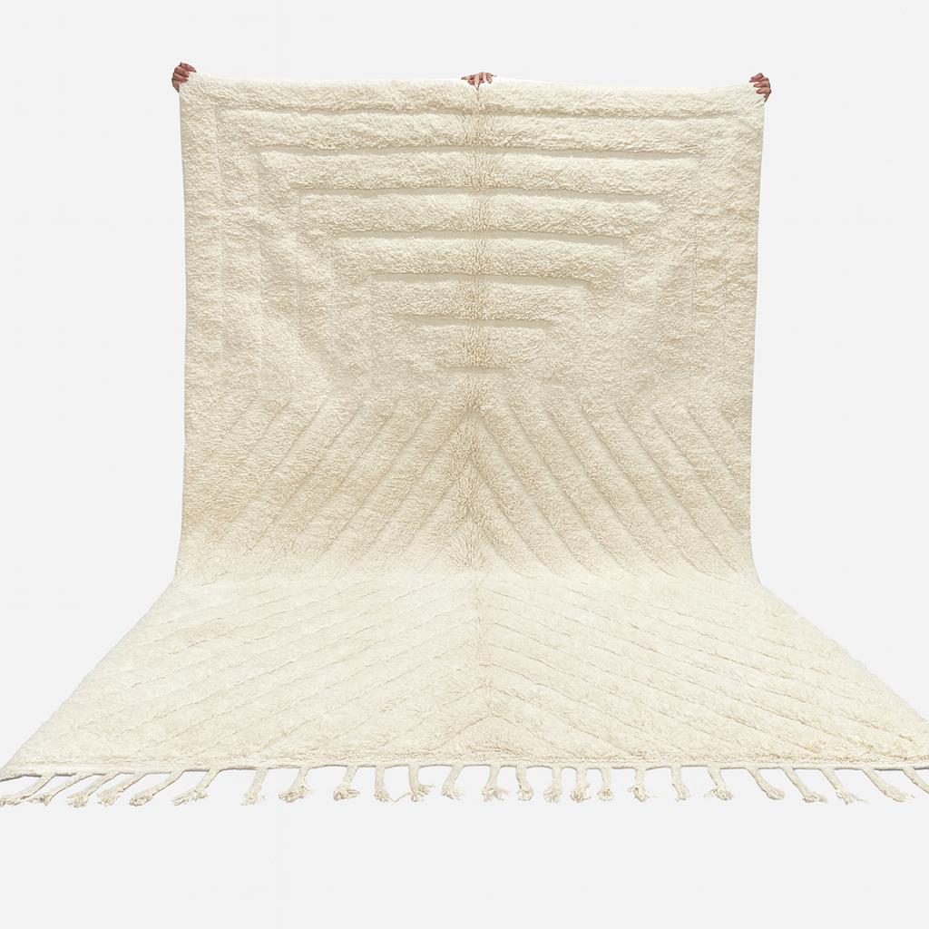 Beige woven rug with a chevron pattern on a white background