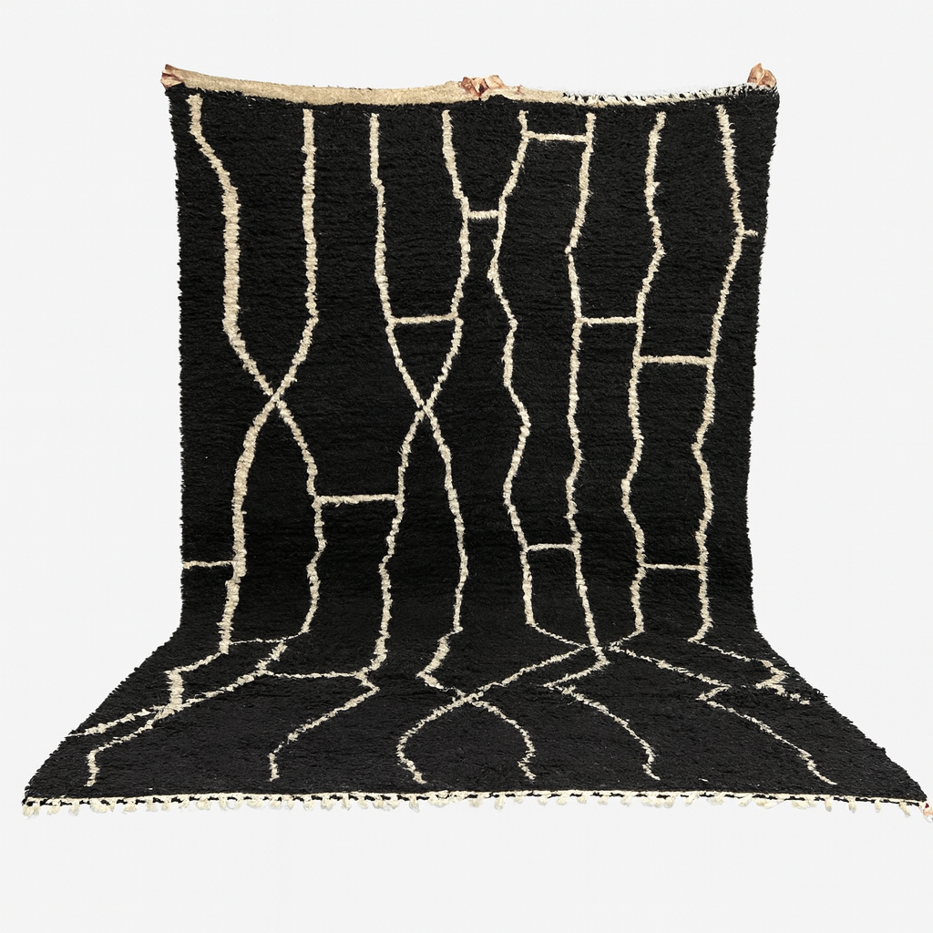 Black rug with white geometric patterns on a white background