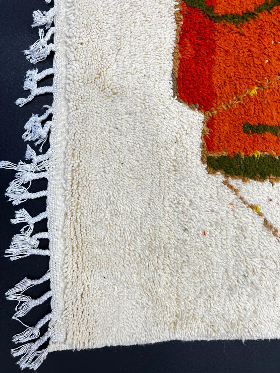 Handmade colorful abstract Moroccan wool runner rug with blue, orange, green, mustard, and cream geometric shapes.