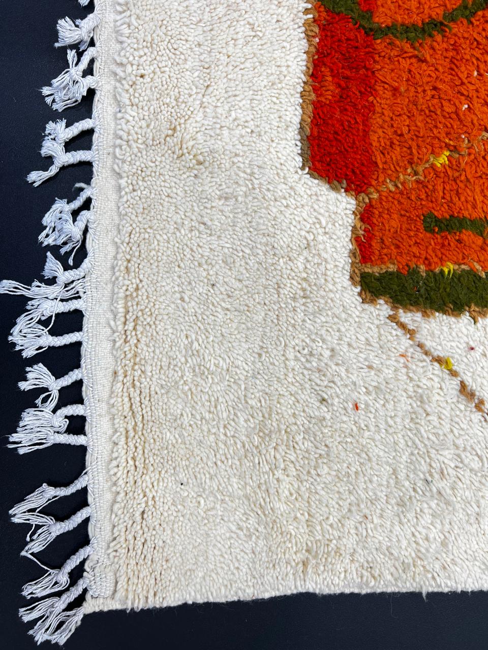 Handmade colorful abstract Moroccan wool runner rug with blue, orange, green, mustard, and cream geometric shapes.