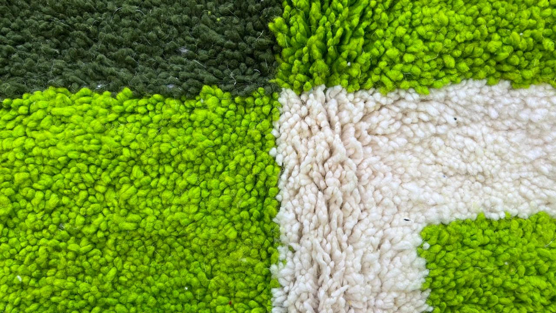 Green abstract Moroccan runner rug with geometric color block design, handmade from wool by Berber artisans.