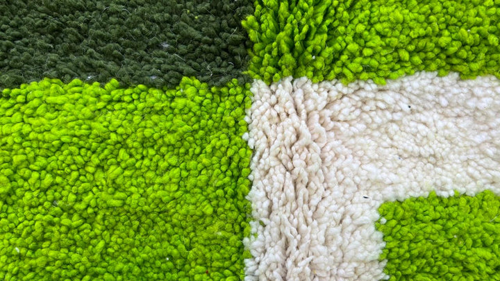 Green abstract Moroccan runner rug with geometric color block design, handmade from wool by Berber artisans.