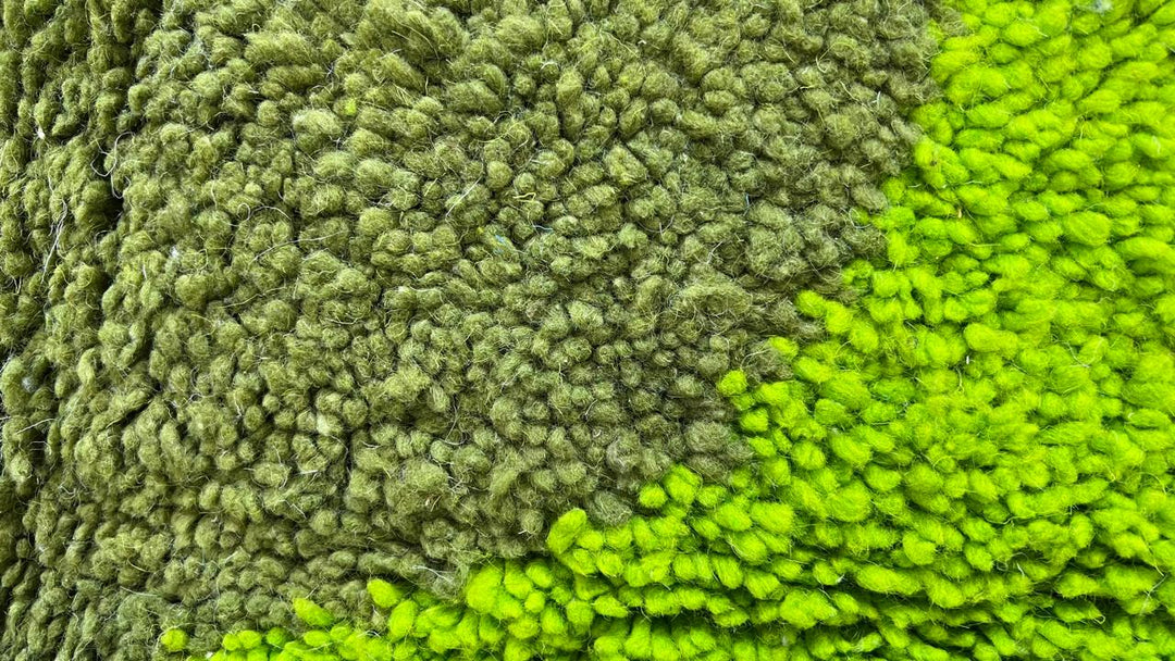 Green abstract Moroccan runner rug with geometric color block design, handmade from wool by Berber artisans.