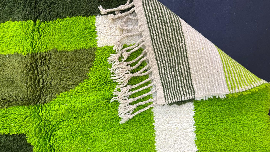 Green abstract Moroccan runner rug with geometric color block design, handmade from wool by Berber artisans.