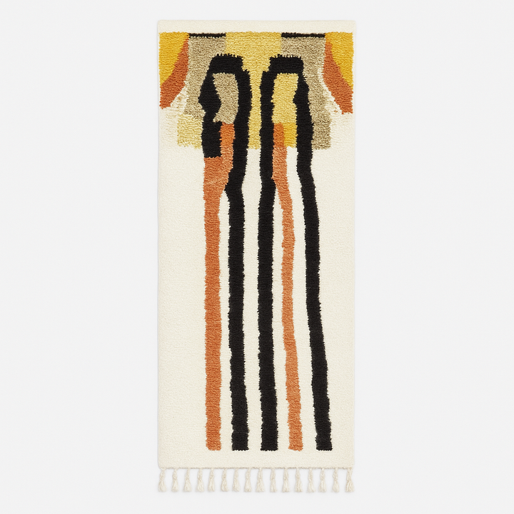 Handmade abstract Moroccan runner rug with black and burnt orange vertical stripes on a white wool base.