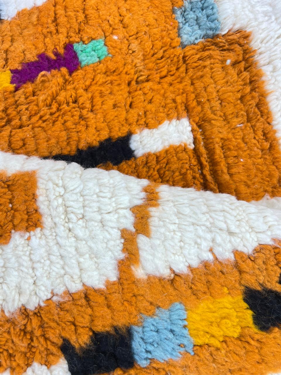 Handmade abstract Moroccan runner rug in white wool with flowing red line design, woven by Berber artisans.