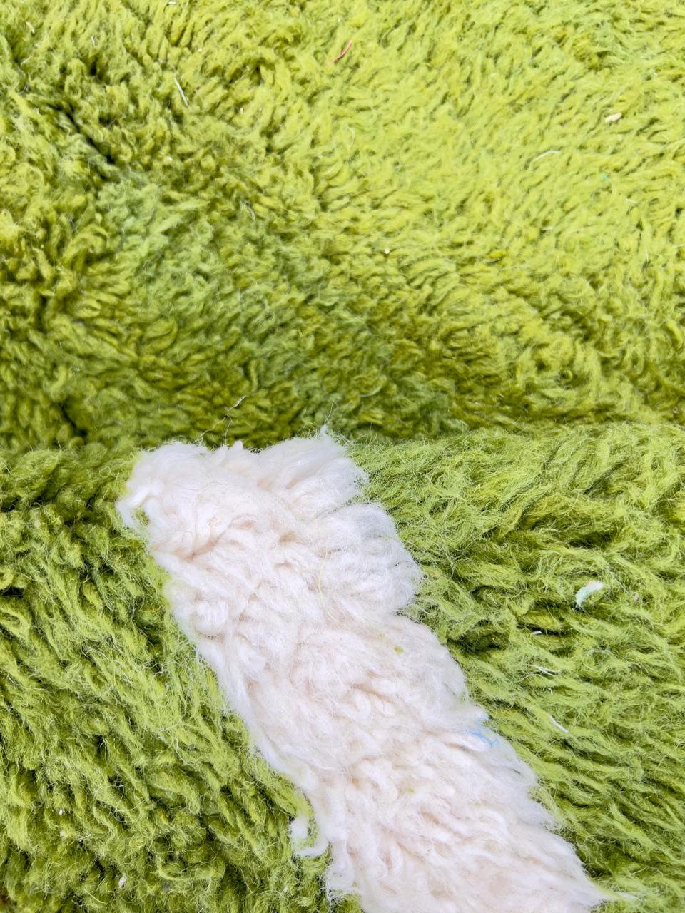 Round abstract Moroccan rug with vibrant green and white organic pattern.