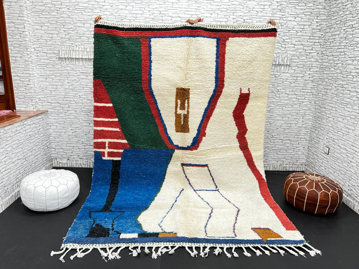Abstract handmade Moroccan wool rug in green, red, blue, brown, and cream – geometric Berber design