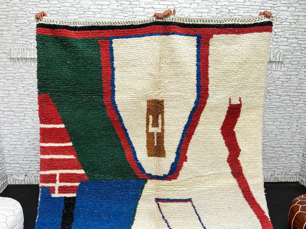 Abstract handmade Moroccan wool rug in green, red, blue, brown, and cream – geometric Berber design