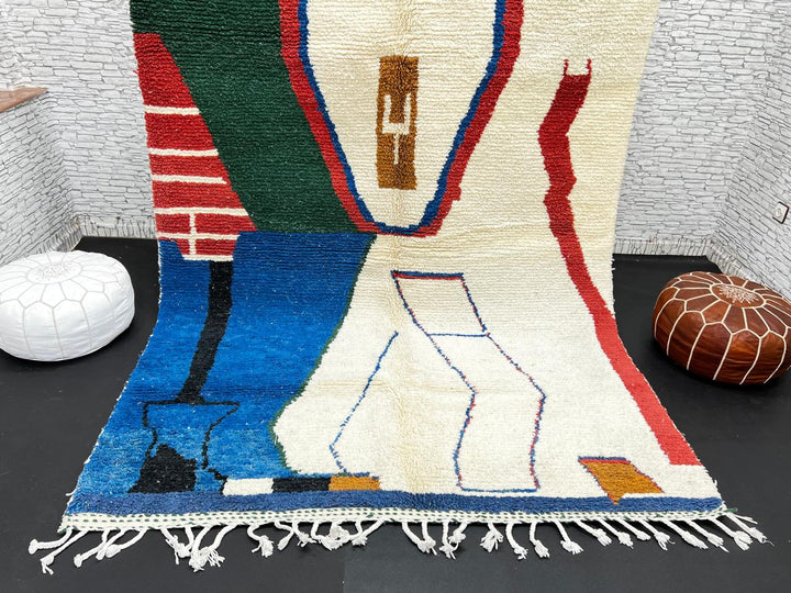 Abstract handmade Moroccan wool rug in green, red, blue, brown, and cream – geometric Berber design