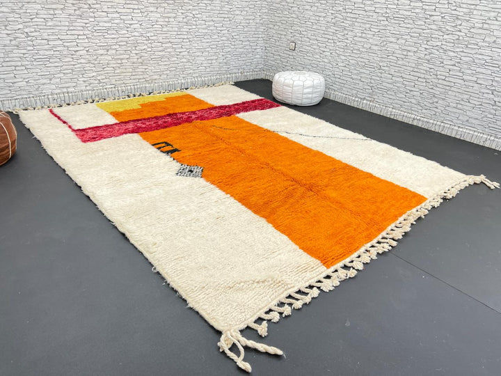 Handwoven abstract Moroccan wool rug with orange, red, and cream geometric design