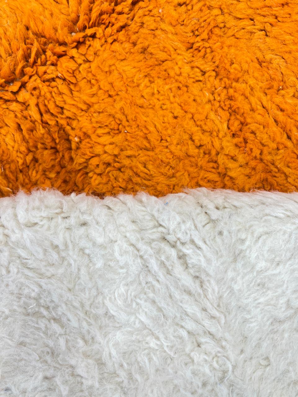 Handwoven abstract Moroccan wool rug with orange, red, and cream geometric design