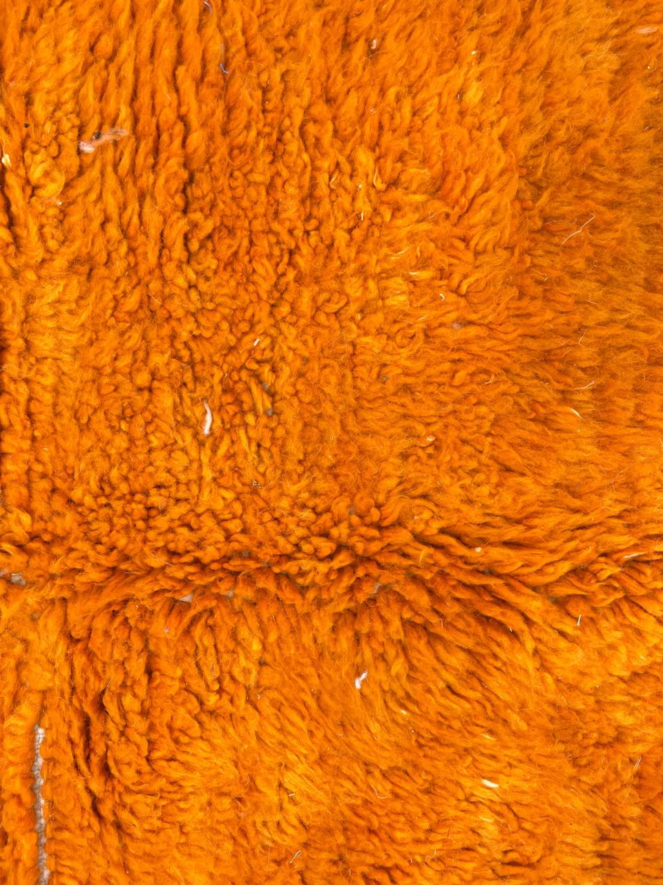 Handwoven abstract Moroccan wool rug with orange, red, and cream geometric design