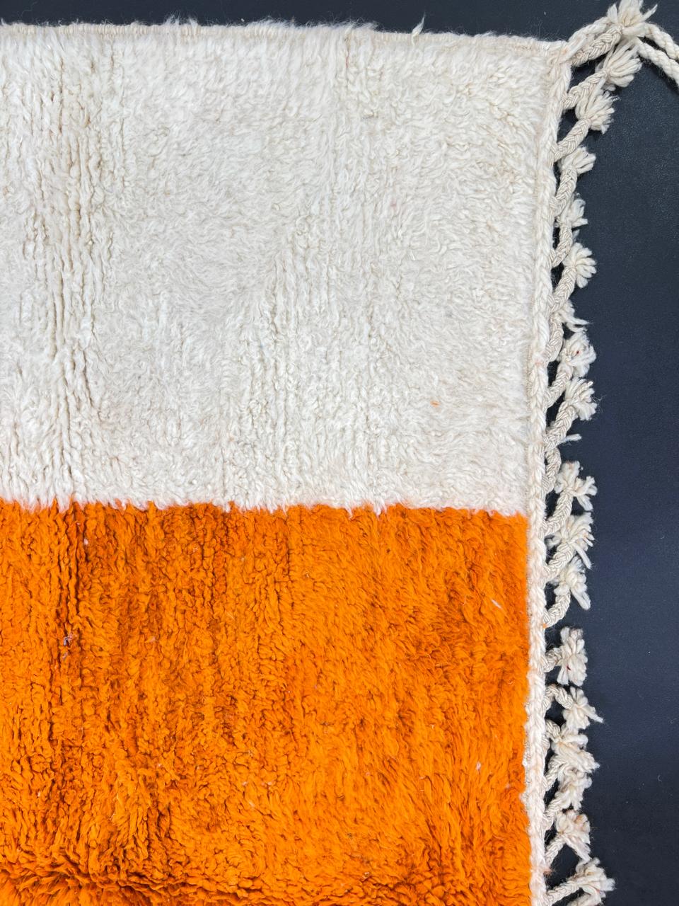 Handwoven abstract Moroccan wool rug with orange, red, and cream geometric design