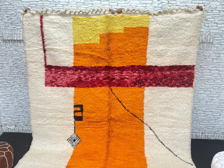 Handwoven abstract Moroccan wool rug with orange, red, and cream geometric design