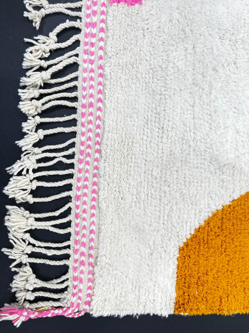 Handmade abstract Moroccan wool runner rug with cream base, pink line, blue shapes, green and mustard geometric accents.