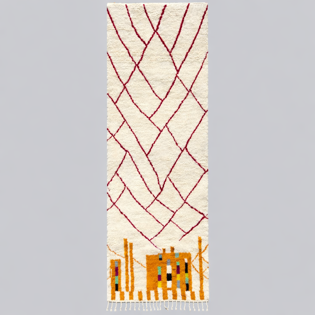 Handmade abstract Moroccan runner rug in white wool with flowing red line design, woven by Berber artisans.
