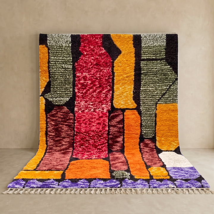 Abstract color block Moroccan wool rug with bold orange, red, green, and purple geometric design
