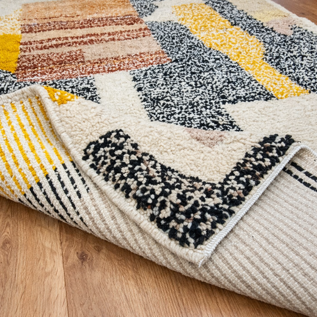 Handmade Moroccan wool rug with abstract earth-tone design. Soft plush texture, modern style, and ethically crafted in Morocco.
