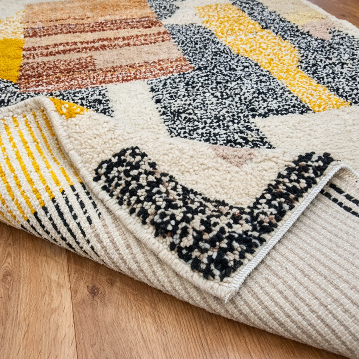 Handmade Moroccan wool rug with abstract earth-tone design. Soft plush texture, modern style, and ethically crafted in Morocco.