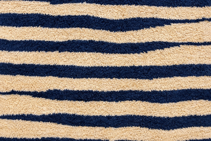 Abstract Moroccan wool rug in beige with black line pattern, handwoven by Berber artisans. Perfect as a contemporary area rug.