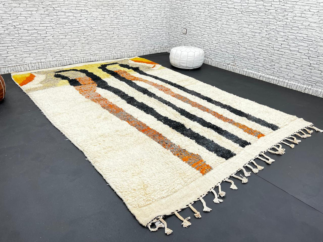 Handmade ivory Moroccan wool rug with orange, black, yellow, and gray abstract stripe patterns – modern Berber rug