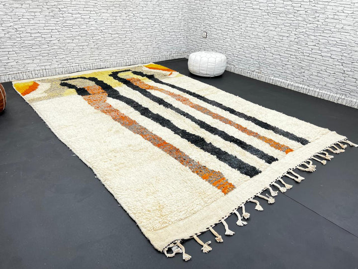 Handmade ivory Moroccan wool rug with orange, black, yellow, and gray abstract stripe patterns – modern Berber rug