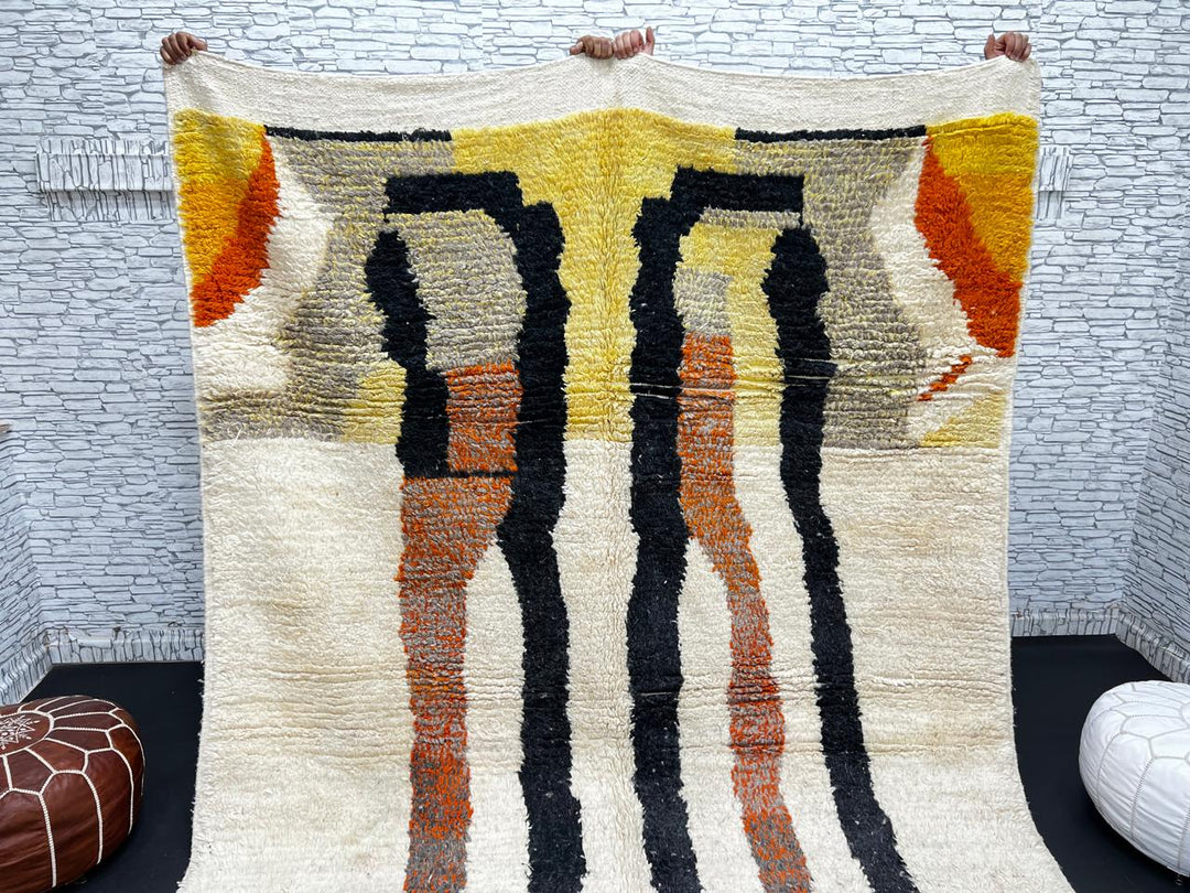 Handmade ivory Moroccan wool rug with orange, black, yellow, and gray abstract stripe patterns – modern Berber rug