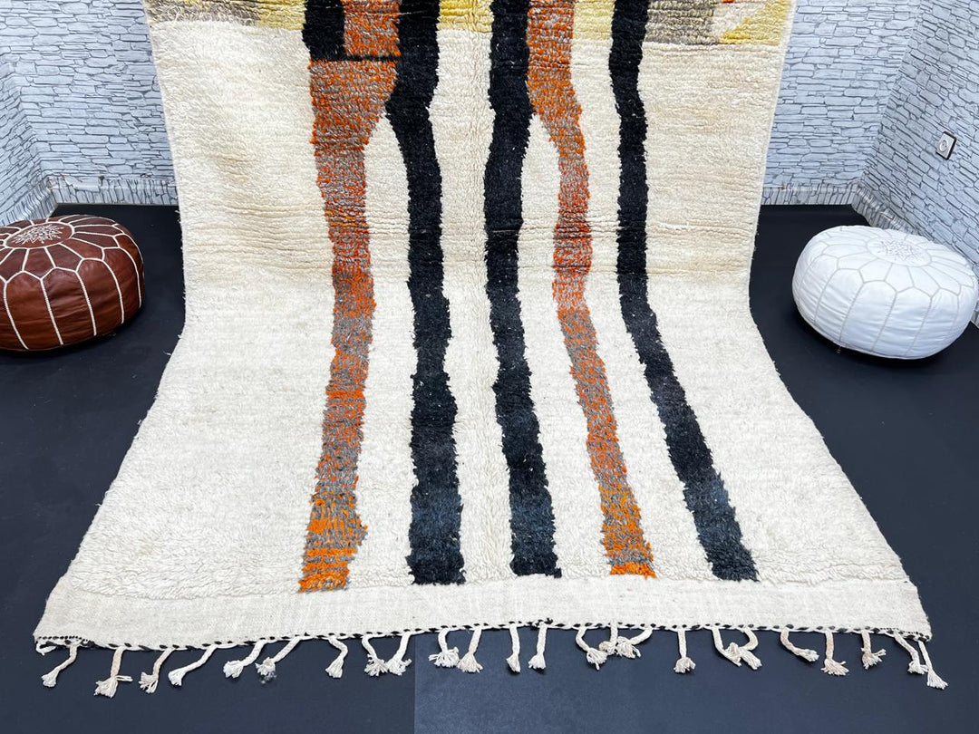 Handmade ivory Moroccan wool rug with orange, black, yellow, and gray abstract stripe patterns – modern Berber rug