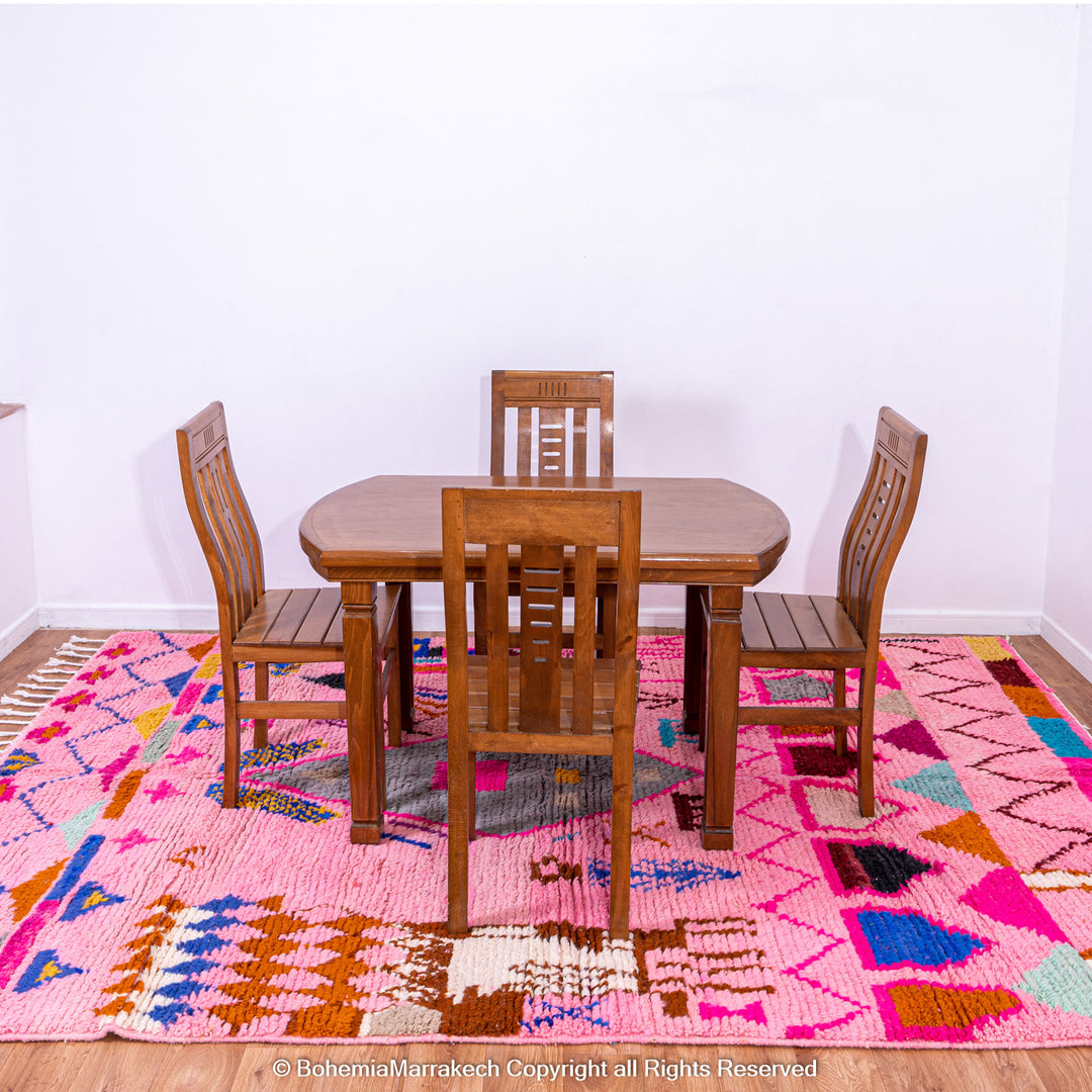 Pink handmade Boujaad Moroccan rug with multicolored tribal symbols and geometric patterns