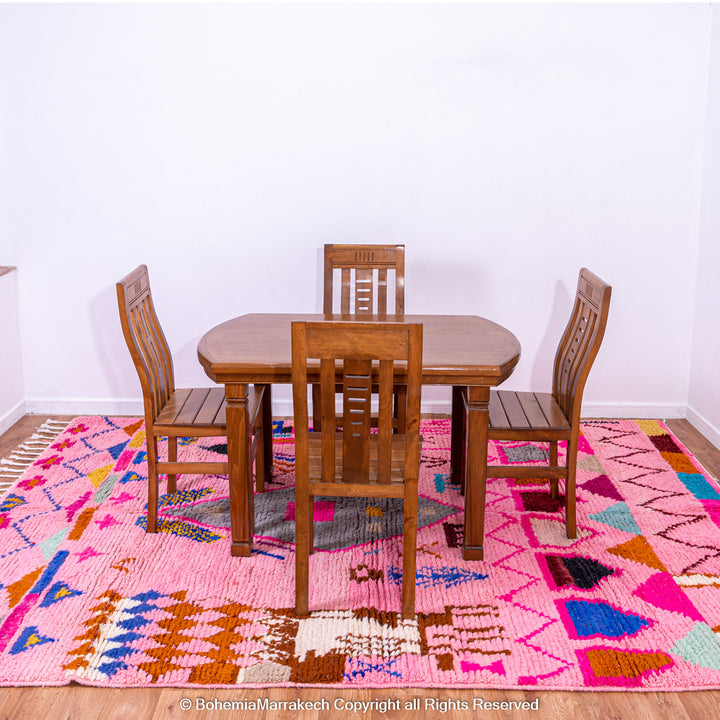 Pink handmade Boujaad Moroccan rug with multicolored tribal symbols and geometric patterns