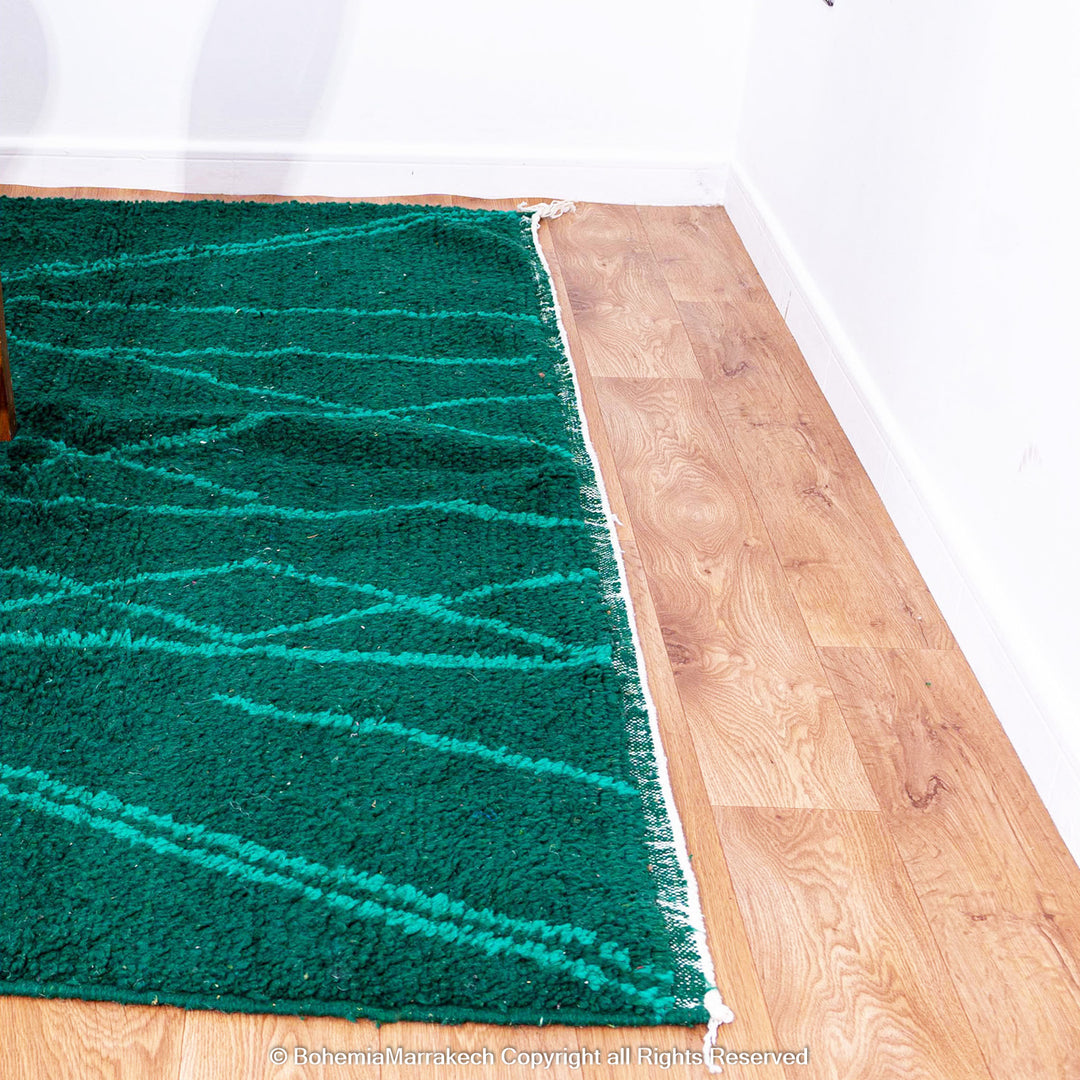 Green Moroccan Boujaad rug with black Berber motifs, handmade in wool by artisans in Morocco