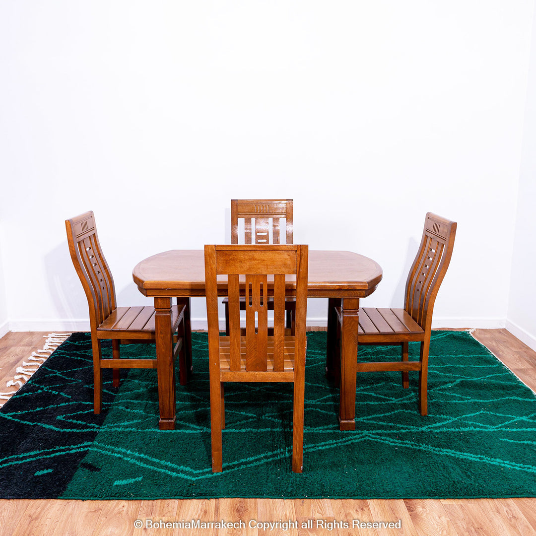 Green Moroccan Boujaad rug with black Berber motifs, handmade in wool by artisans in Morocco