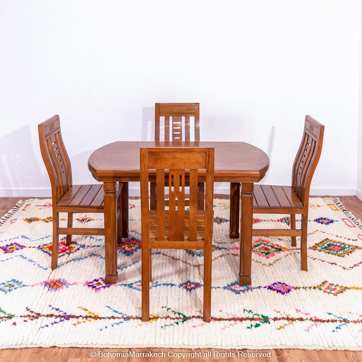 Handmade Beni Ourain Moroccan wool rug with colorful Berber diamonds on a white shag background