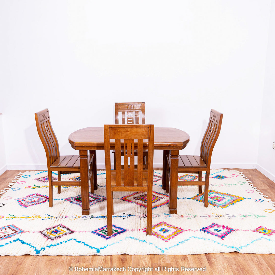 Colorful handmade Boujaad Moroccan rug with traditional Berber diamond patterns on a cream wool background