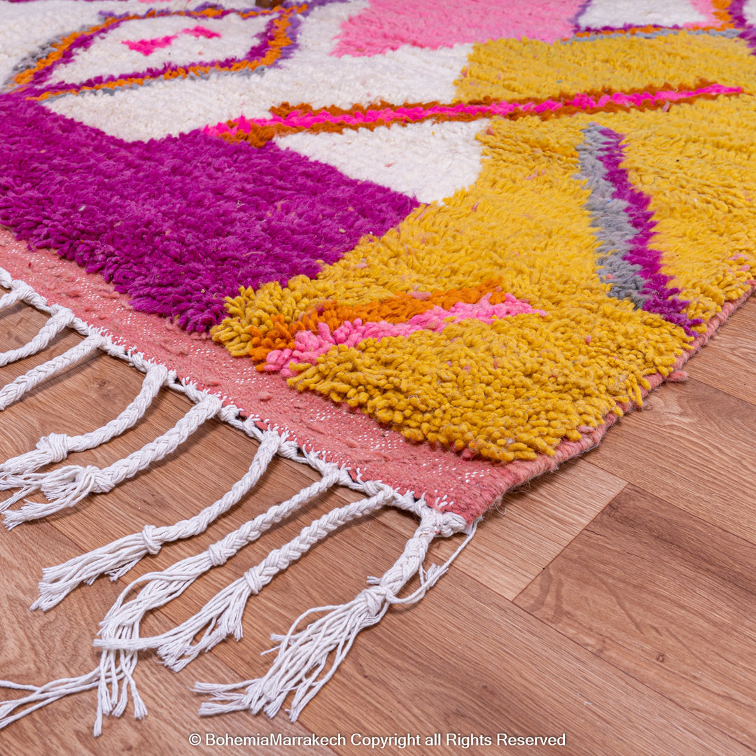 Multicolored Moroccan Boujaad Rug handmade with wool, featuring vibrant pink, yellow, and blue Berber patterns.