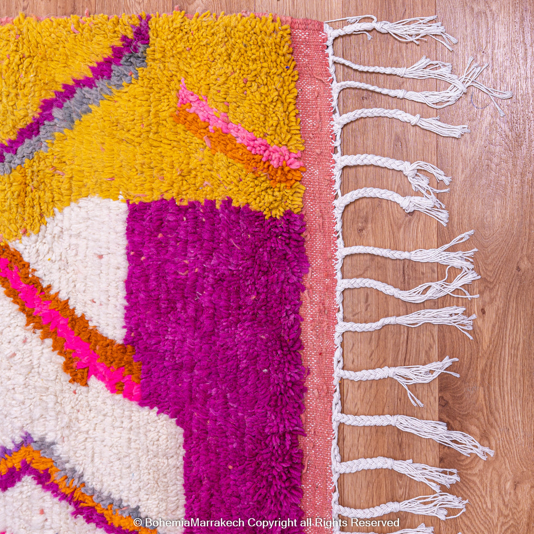 Multicolored Moroccan Boujaad Rug handmade with wool, featuring vibrant pink, yellow, and blue Berber patterns.