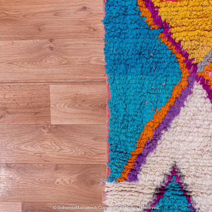 Multicolored Moroccan Boujaad Rug handmade with wool, featuring vibrant pink, yellow, and blue Berber patterns.