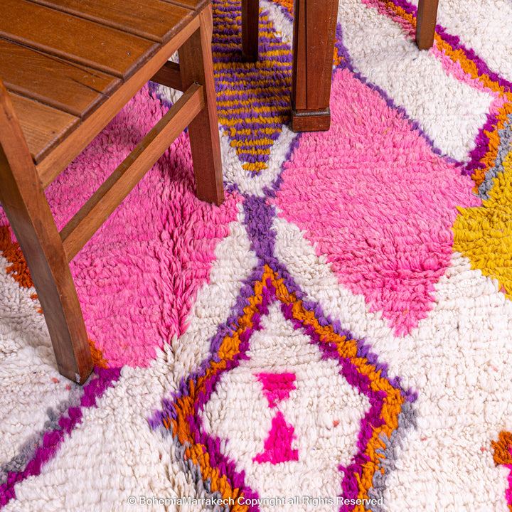 Multicolored Moroccan Boujaad Rug handmade with wool, featuring vibrant pink, yellow, and blue Berber patterns.