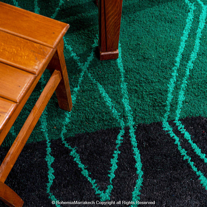 Green Moroccan Boujaad rug with black Berber motifs, handmade in wool by artisans in Morocco