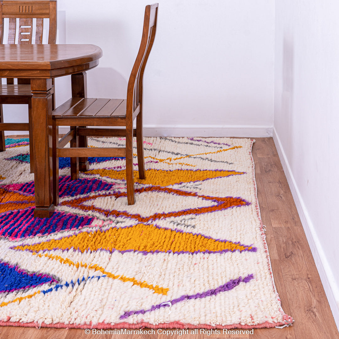 Multicolored Moroccan Boujaad Rug handmade with wool, featuring vibrant pink, yellow, and blue Berber patterns.