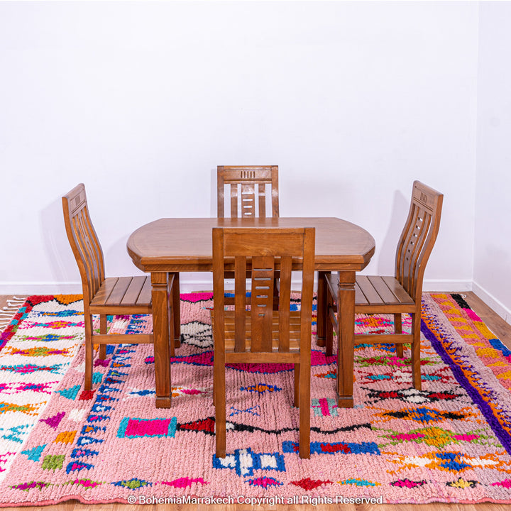 Handmade pink Boujaad Moroccan rug with colorful tribal and diamond motifs on wool