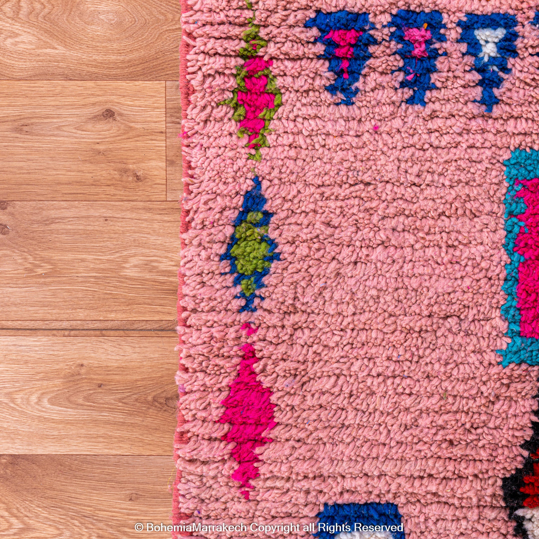 Handmade pink Boujaad Moroccan rug with colorful tribal and diamond motifs on wool