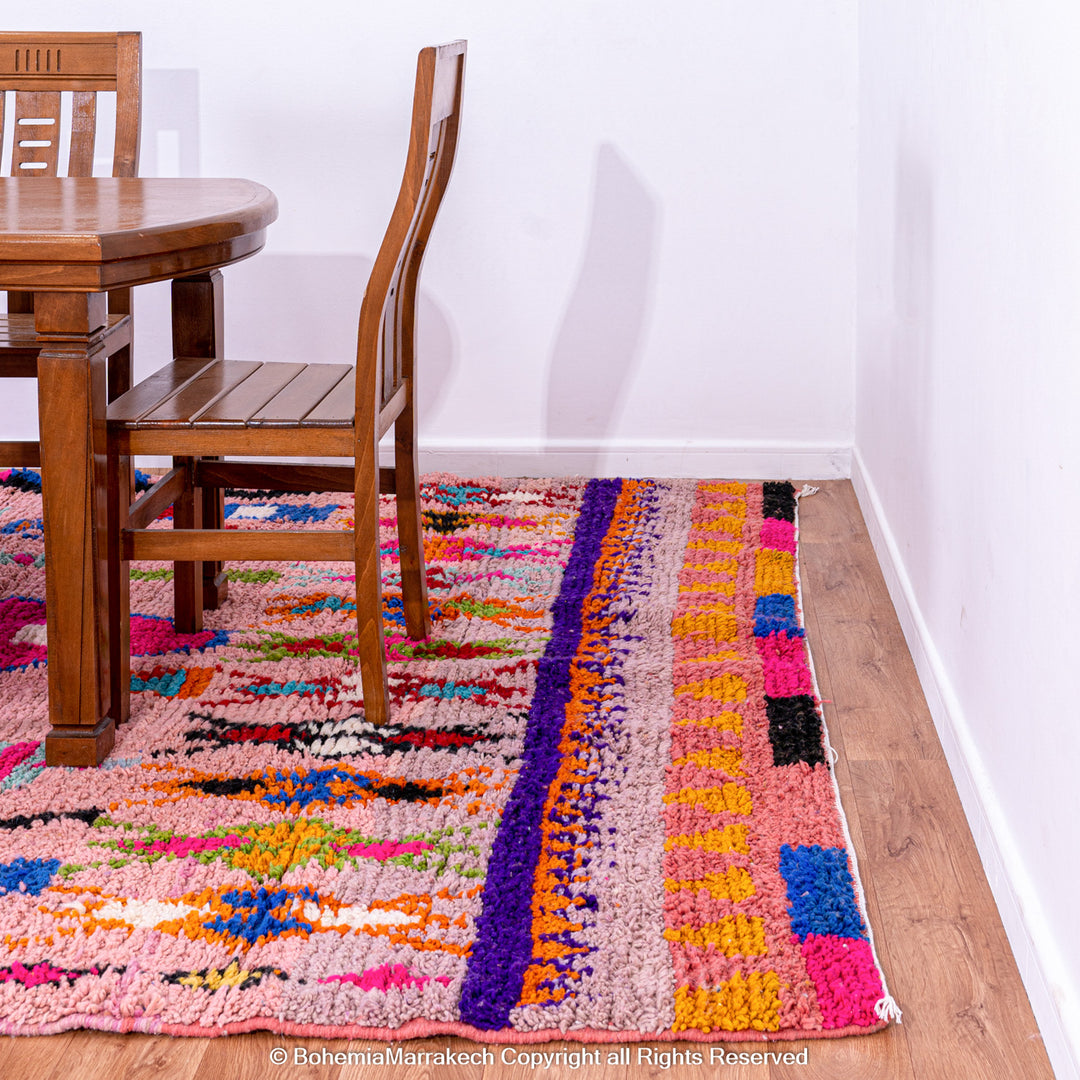 Handmade pink Boujaad Moroccan rug with colorful tribal and diamond motifs on wool