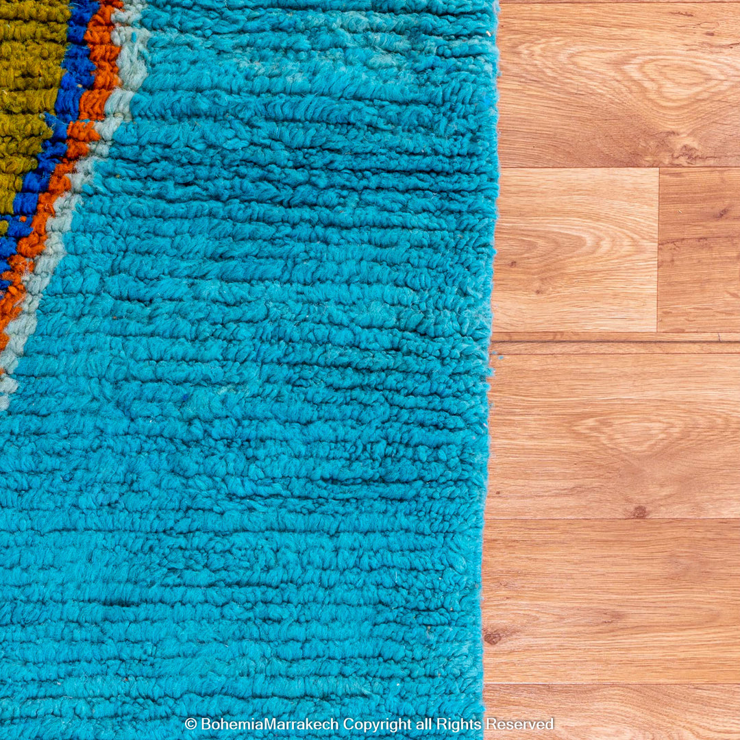 Blue Moroccan Boujaad rug with bold multicolor geometric Berber patterns, handmade in wool