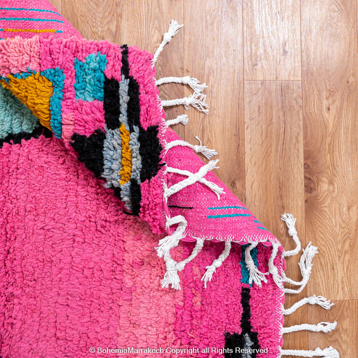 Pink Moroccan Boujaad rug with colorful geometric motifs, handmade in soft wool by Berber artisans