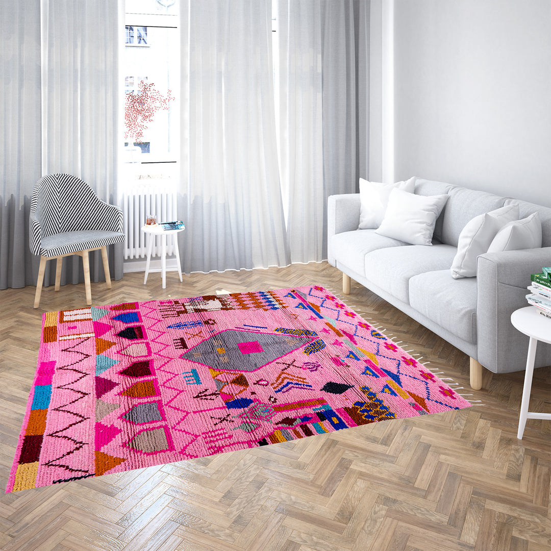 Pink handmade Boujaad Moroccan rug with multicolored tribal symbols and geometric patterns