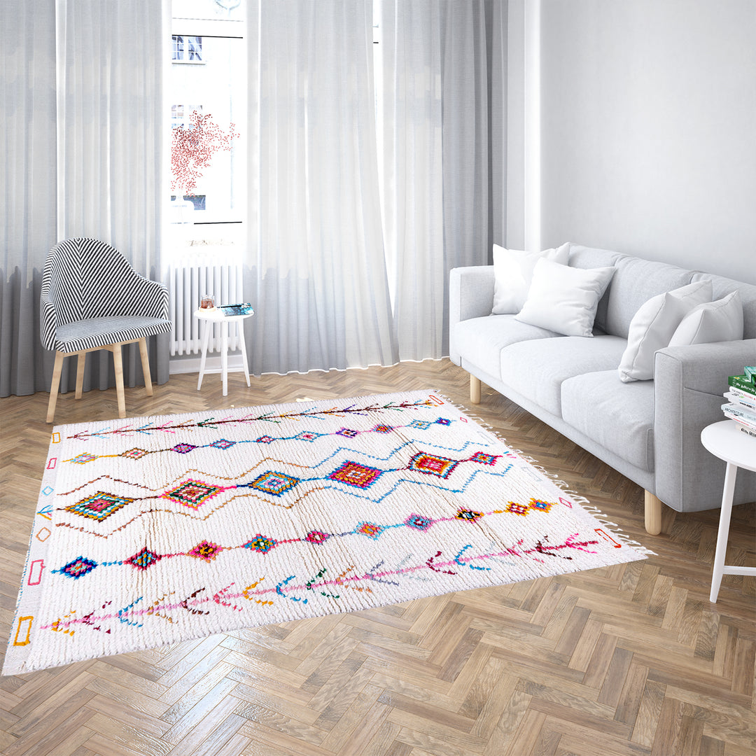 Handmade Beni Ourain Moroccan wool rug with colorful Berber diamonds on a white shag background