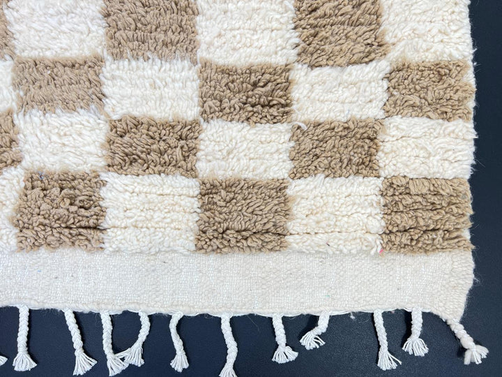 Handmade Moroccan runner rug with beige and white checkerboard pattern crafted from natural wool.
