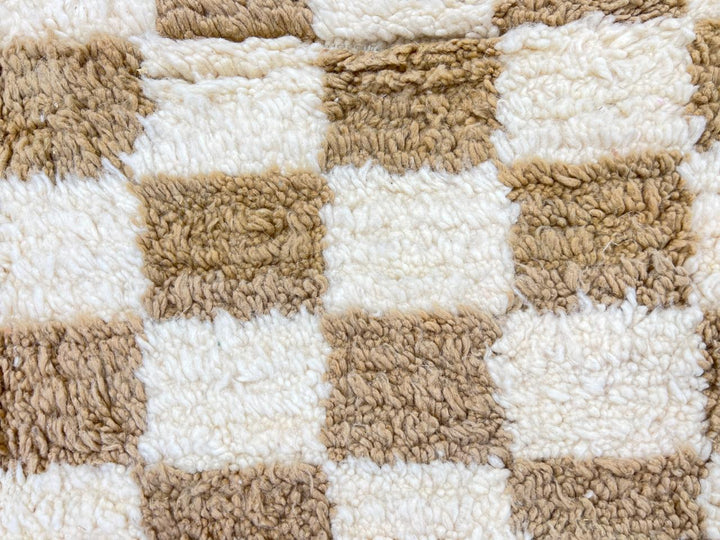 Handwoven beige and cream Moroccan wool rug with checkered design